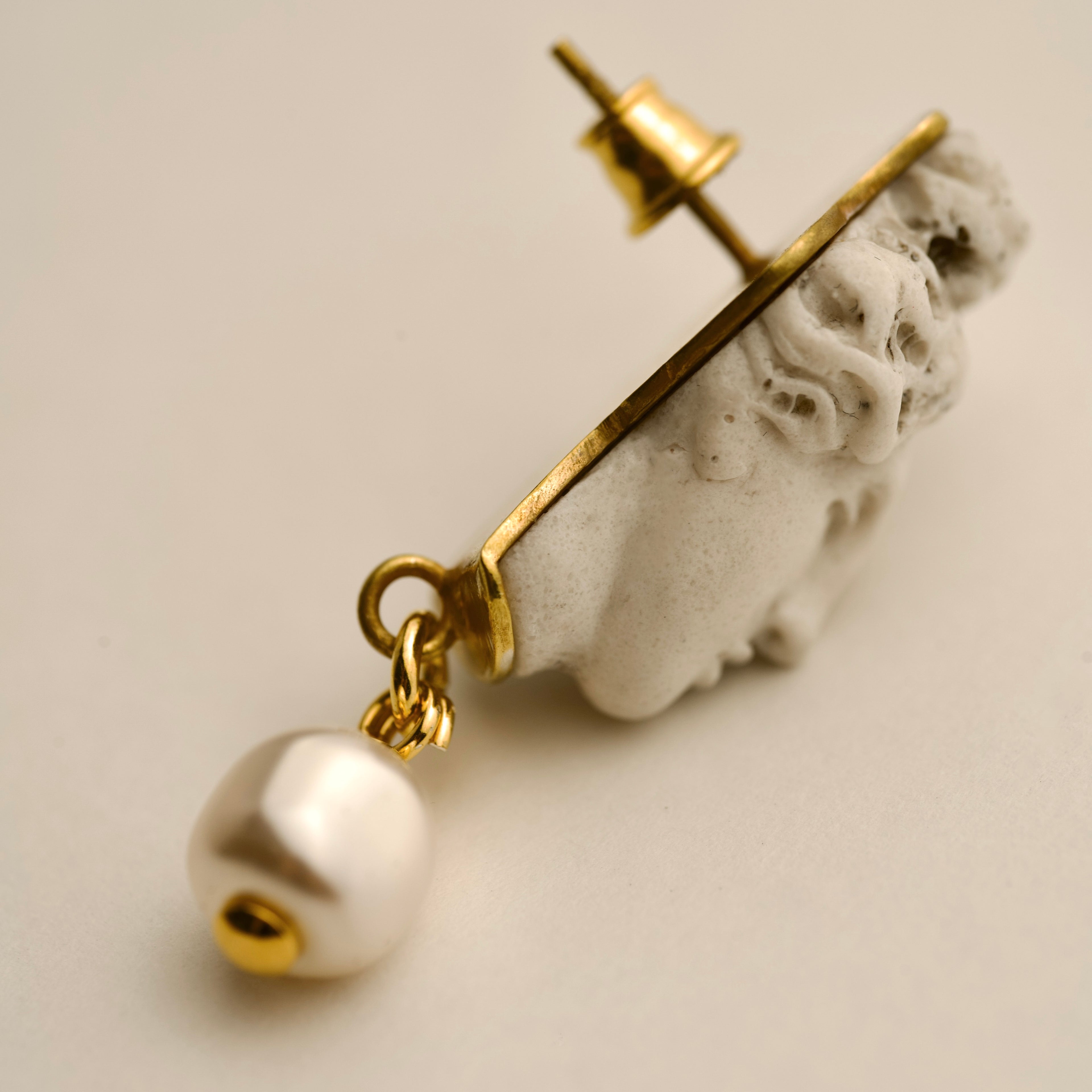 Aphrodite earring stud statement with goddess head design on beige background, handcrafted mythology jewelry