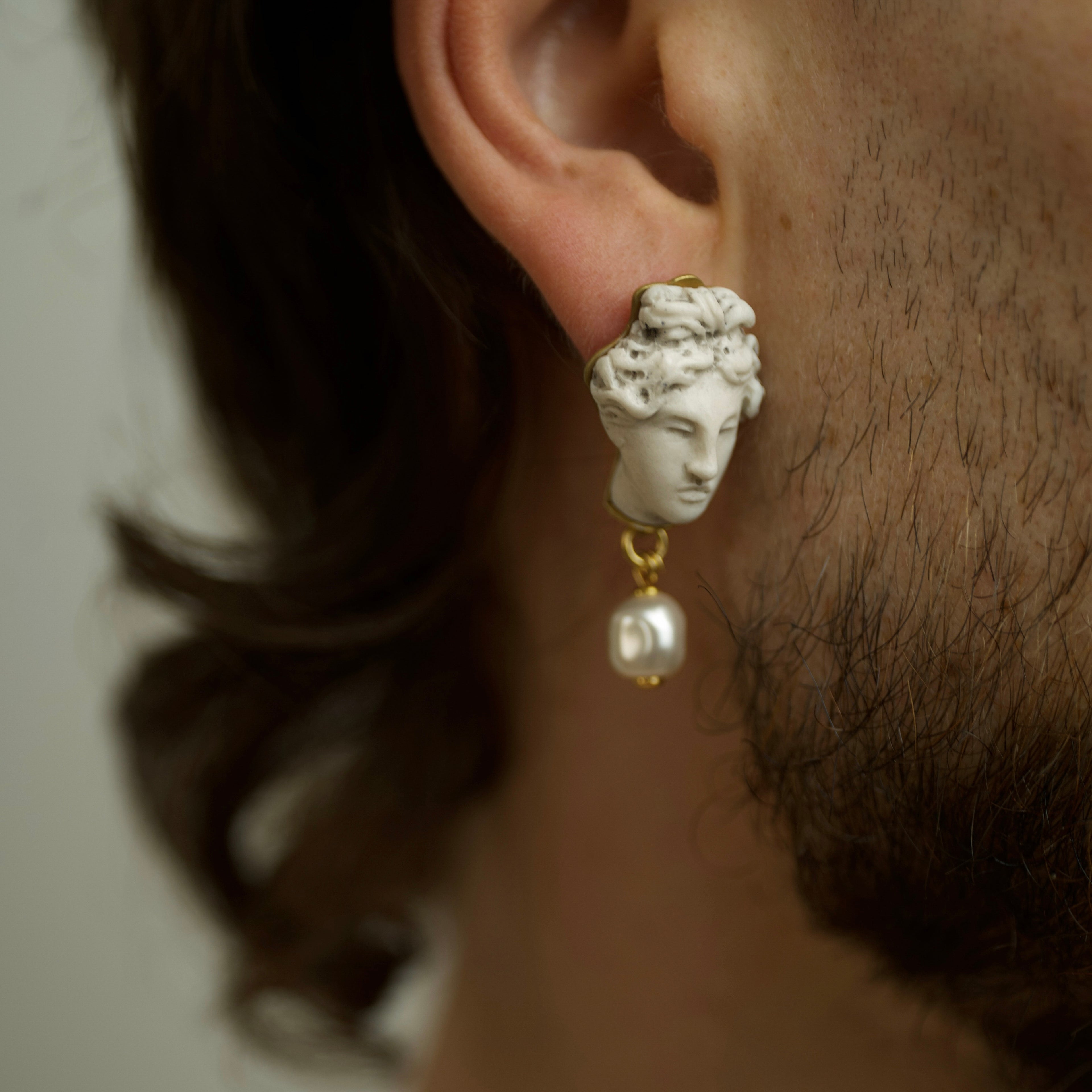 Male model wearing Aphrodite earring - boho earring with classical head design and pearl drop 