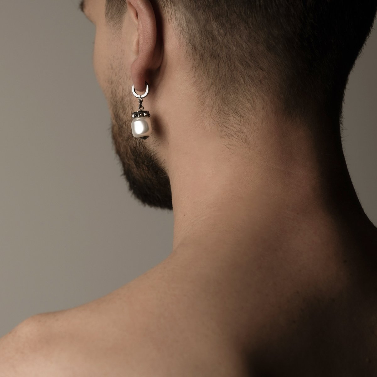 Male model wearing Baroque pearl earring demonstrating fit and dimensions