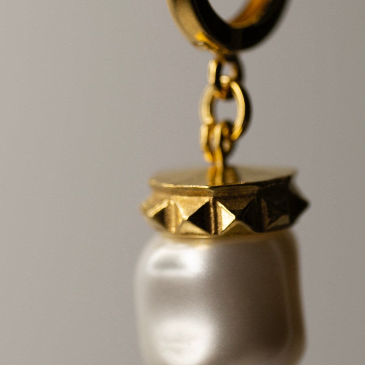 Baroque pearl earring close-up showing gold-plated studs elements, Ancient Greek inspired jewelry detail