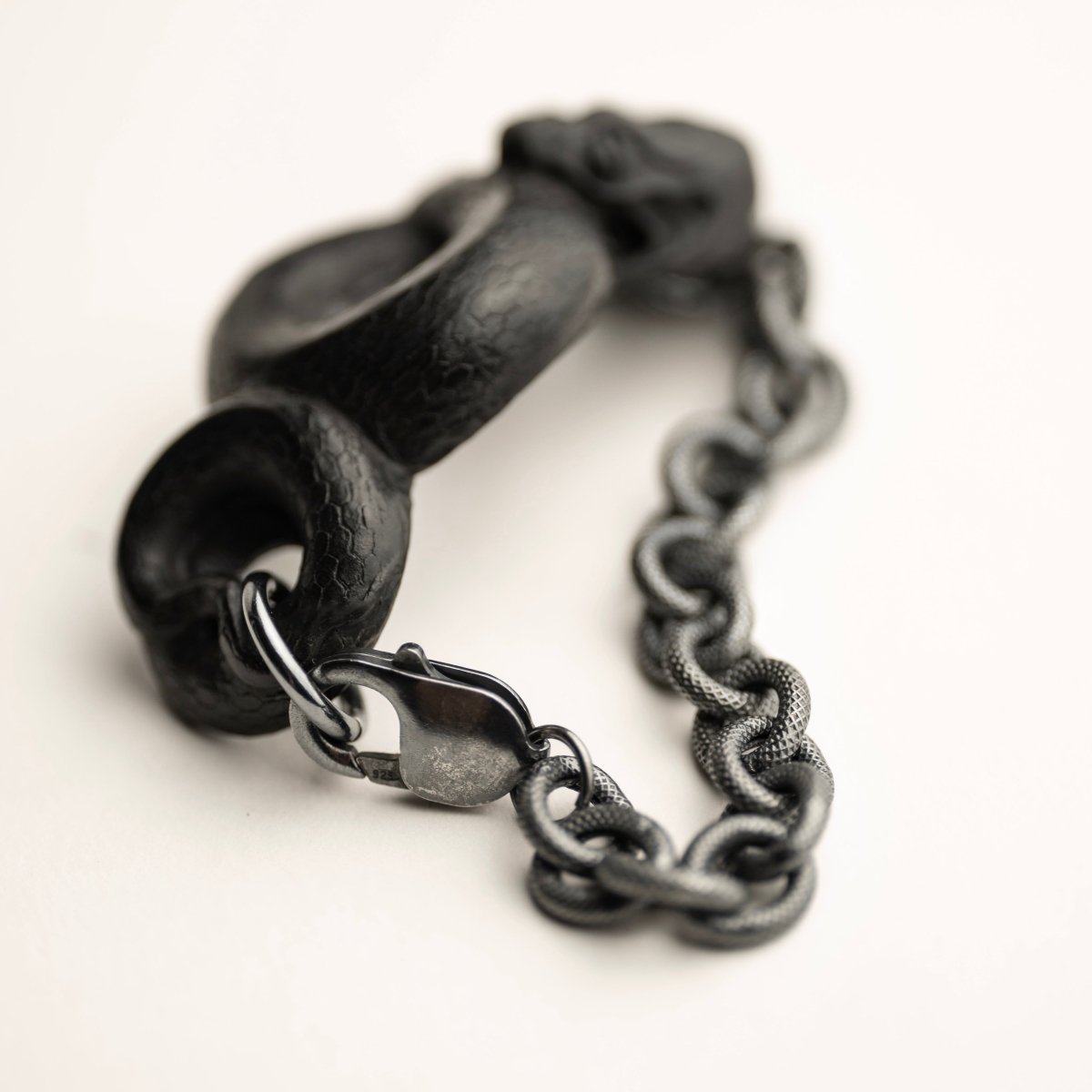 Black Snake bracelet -placed on white surface