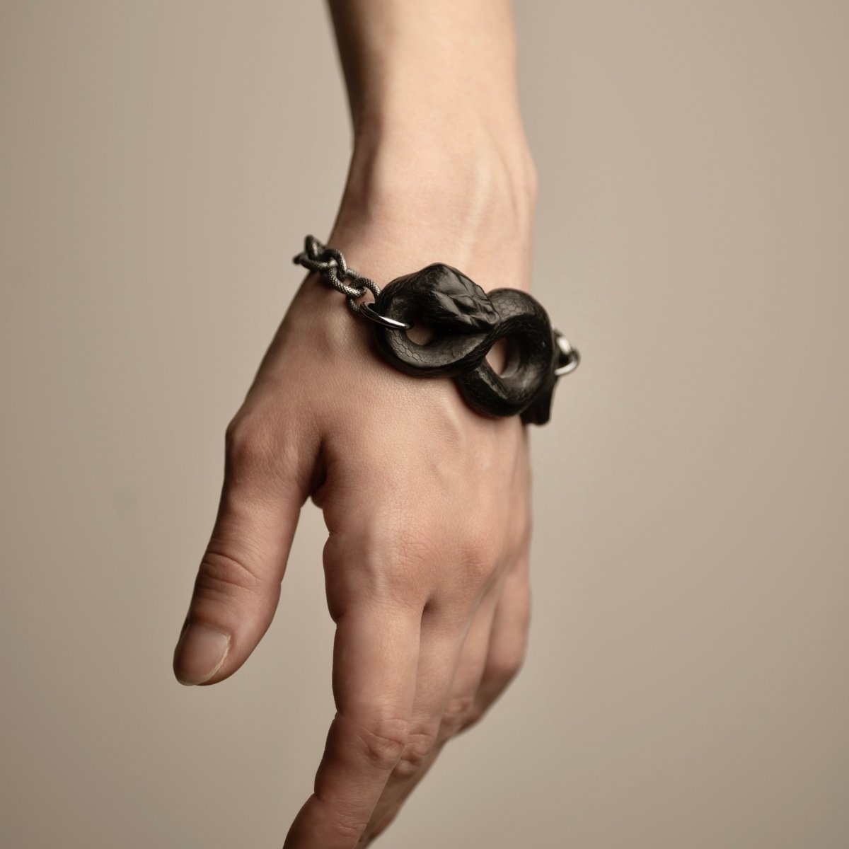 Black Snake bracelet on a hand of a female model