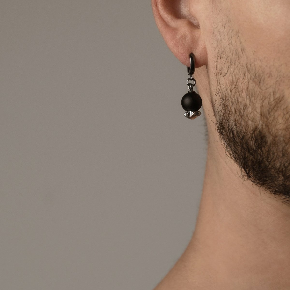 Male model wearing Blueberry earring by Macabre Gadgets, close-up