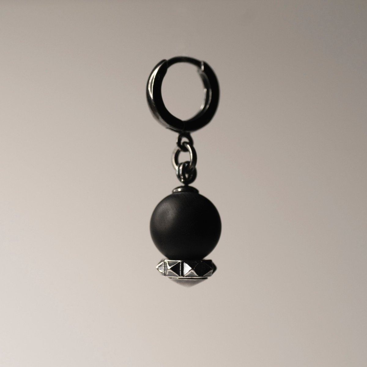 Blueberry earring - silver variant - on neutral background, focus on huggie clasp and silver details