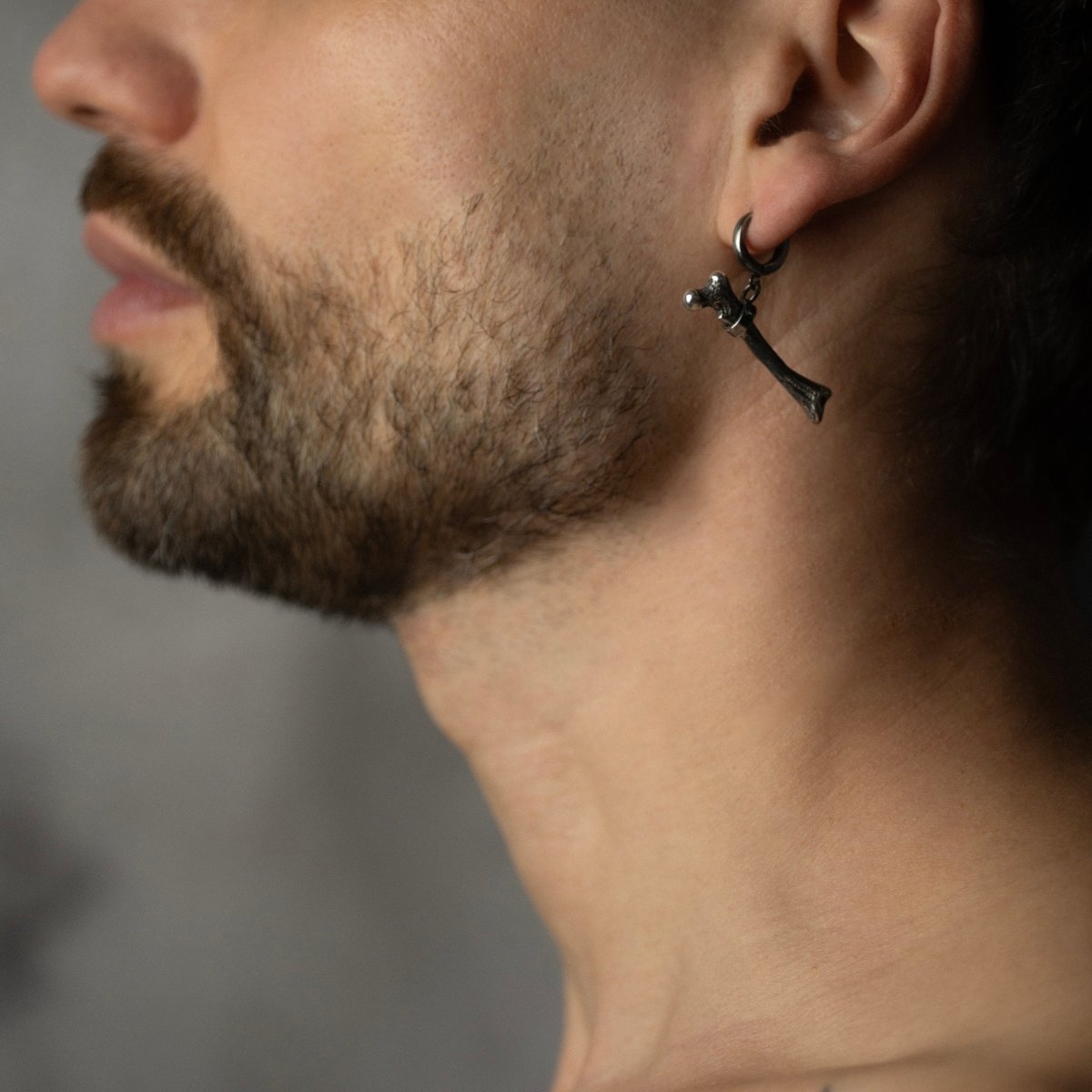Silver Bone earring on a male bearded model