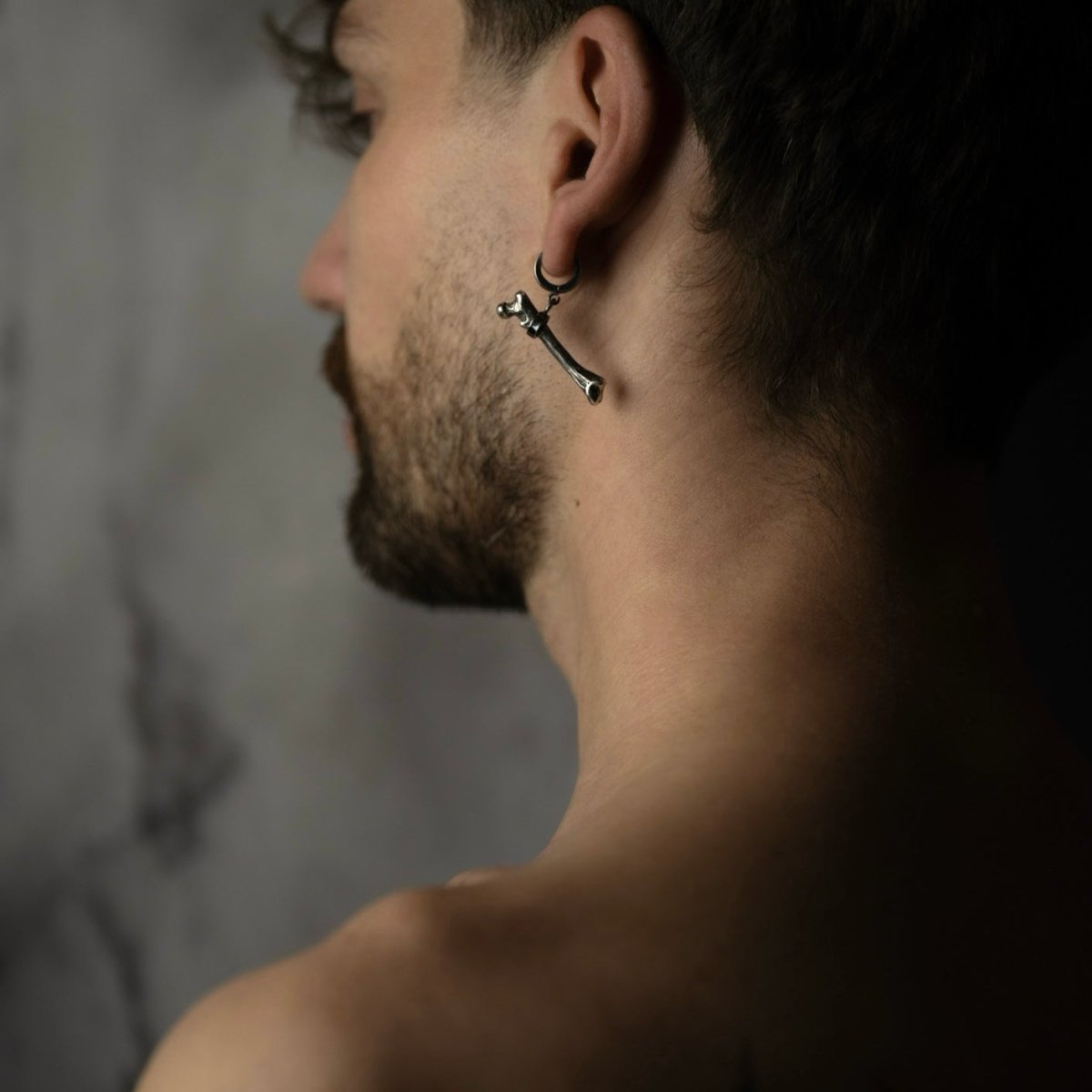 Silver Bone earring on a male model from different angle
