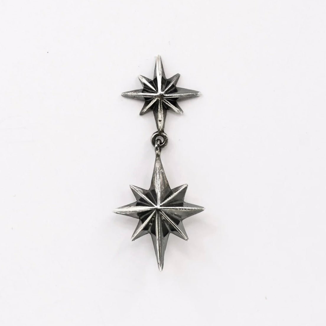 Castor & Pollux earring by Macabre Gadgets on white background, handcrafted sterling silver celestial jewelry with twin stars design