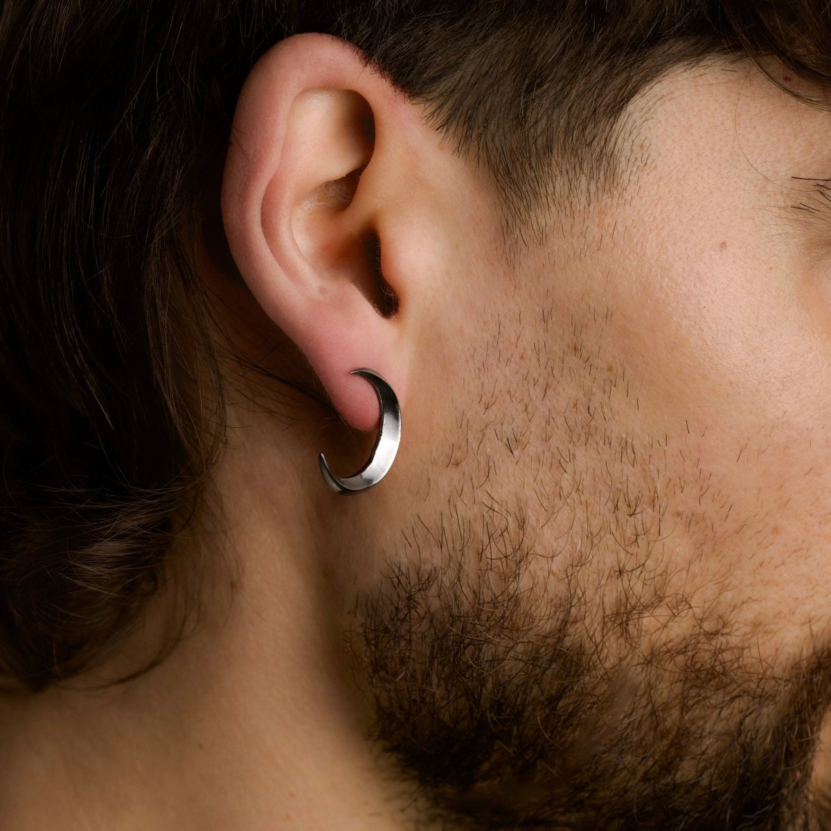 Luna earring on a male model, close-up