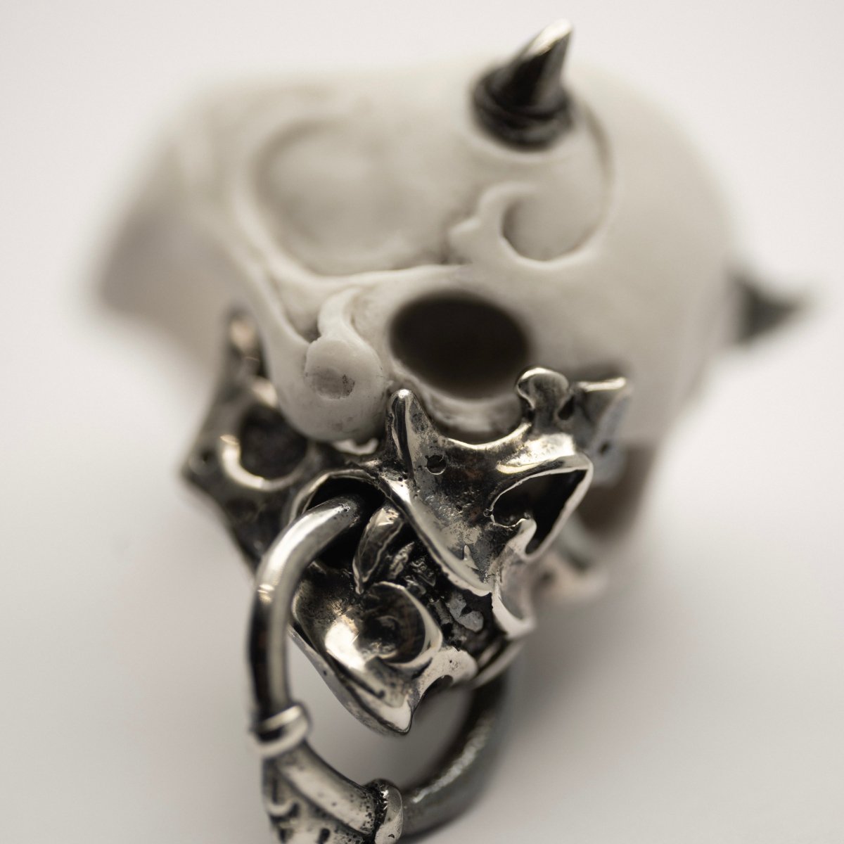 Masked Skull ring - white variant - close up of a sterling silver mask, focus on elaborate details