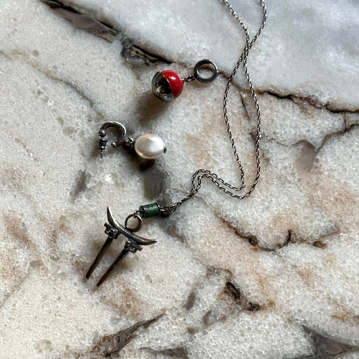 Moonglade Gate pendant with two earrings by Macabre Gadgets on a white marble surface