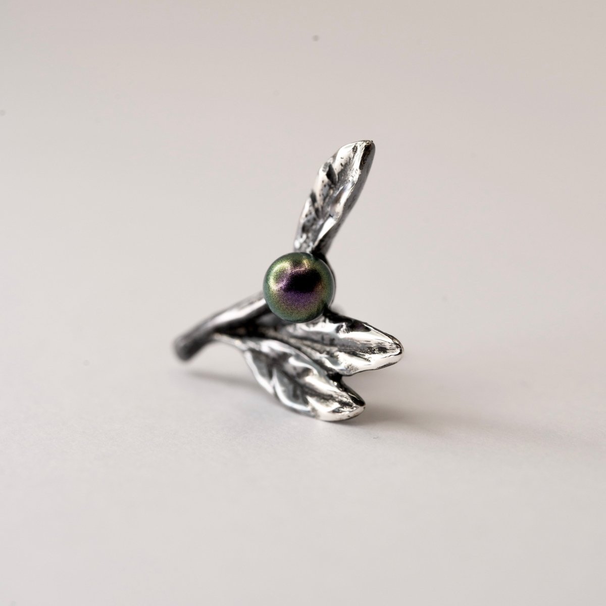 Olive Branch earring sterling silver floral stud with botanical design on neutral background, nature-inspired jewelry
