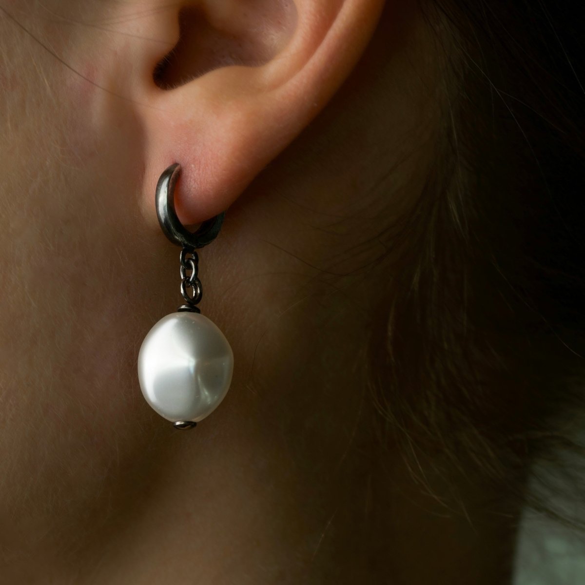 Female model wearing Pearl Coin earring - handcrafted glass pearl and sterling silver earring, close-up
