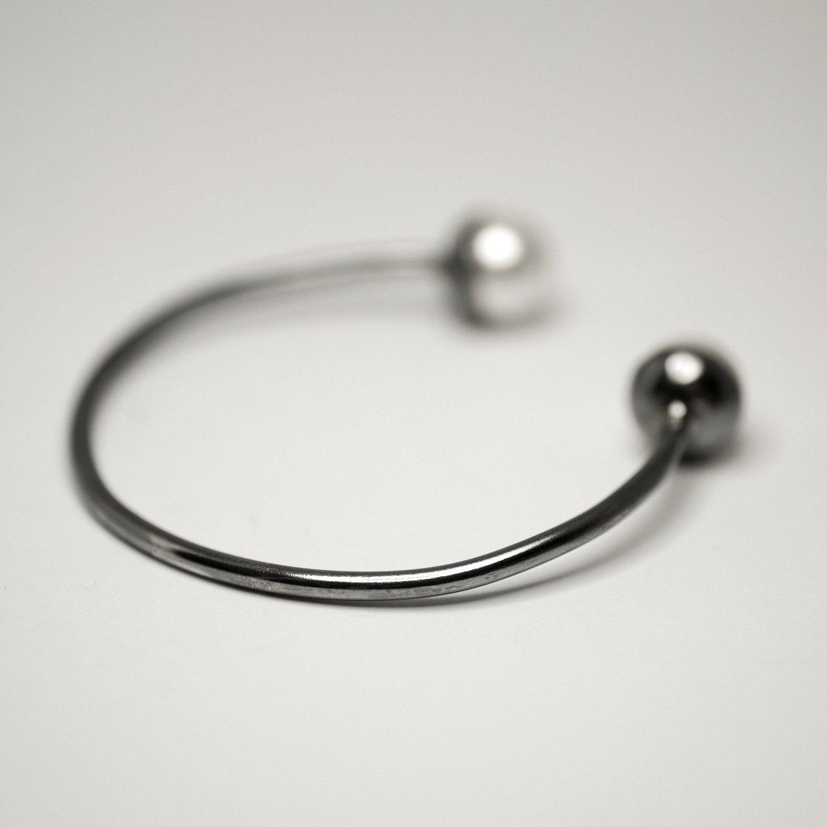 Pearl cuff bracelet side view showing open cuff design and sterling silver texture.