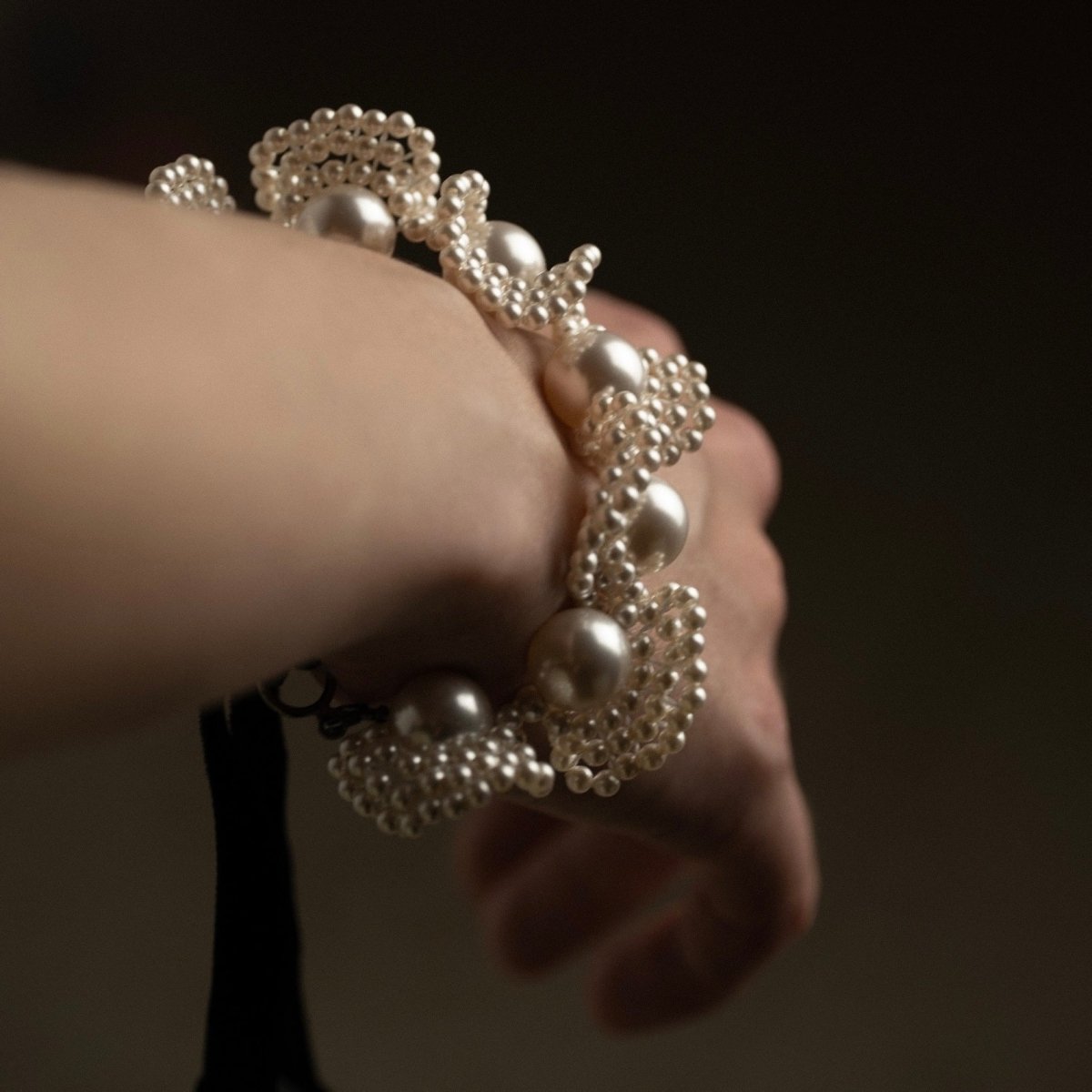 Pearl Lace bracelet - close up on a models  wrist showing woven pearls 