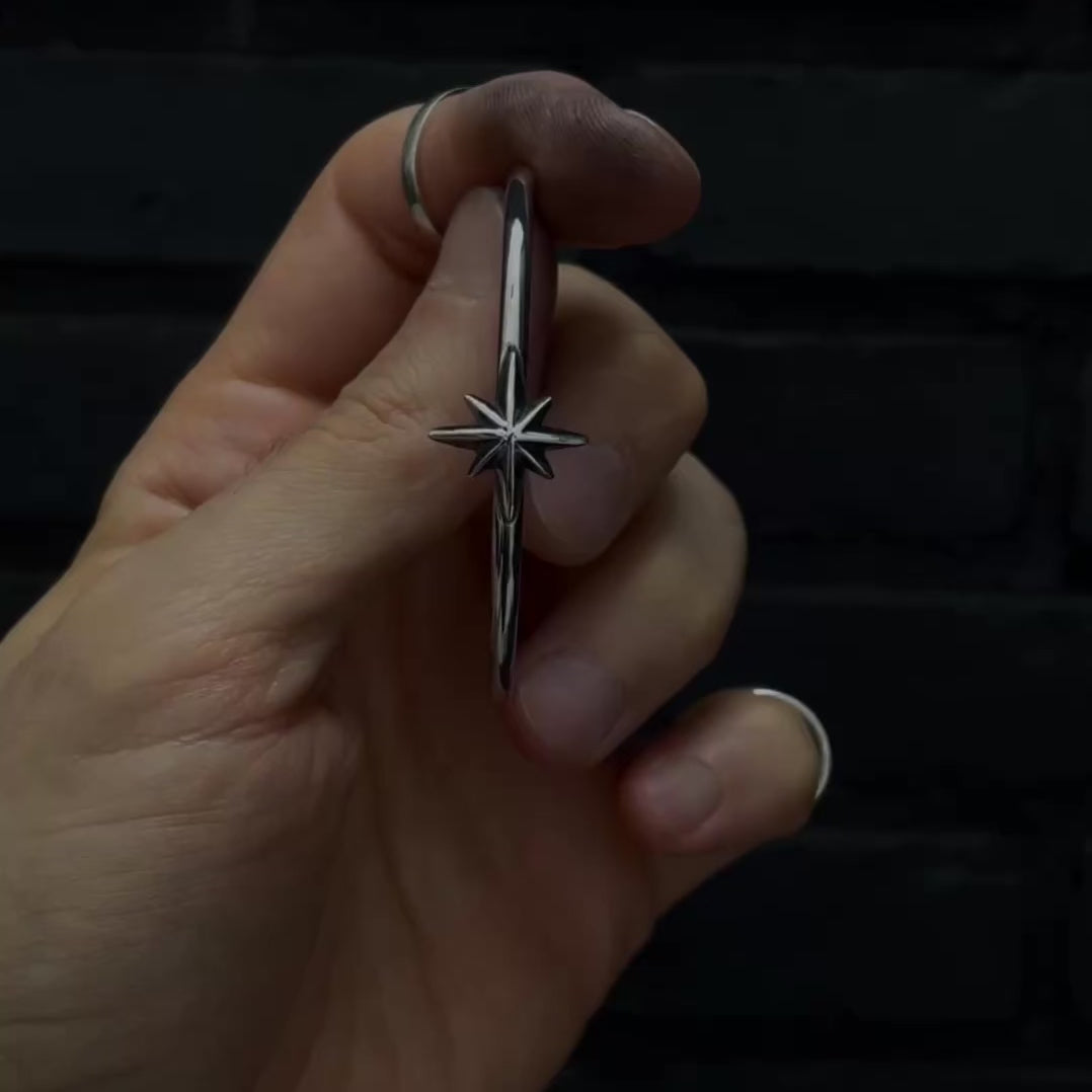 Video of sterling silver bangle, freshly  polished, against black background