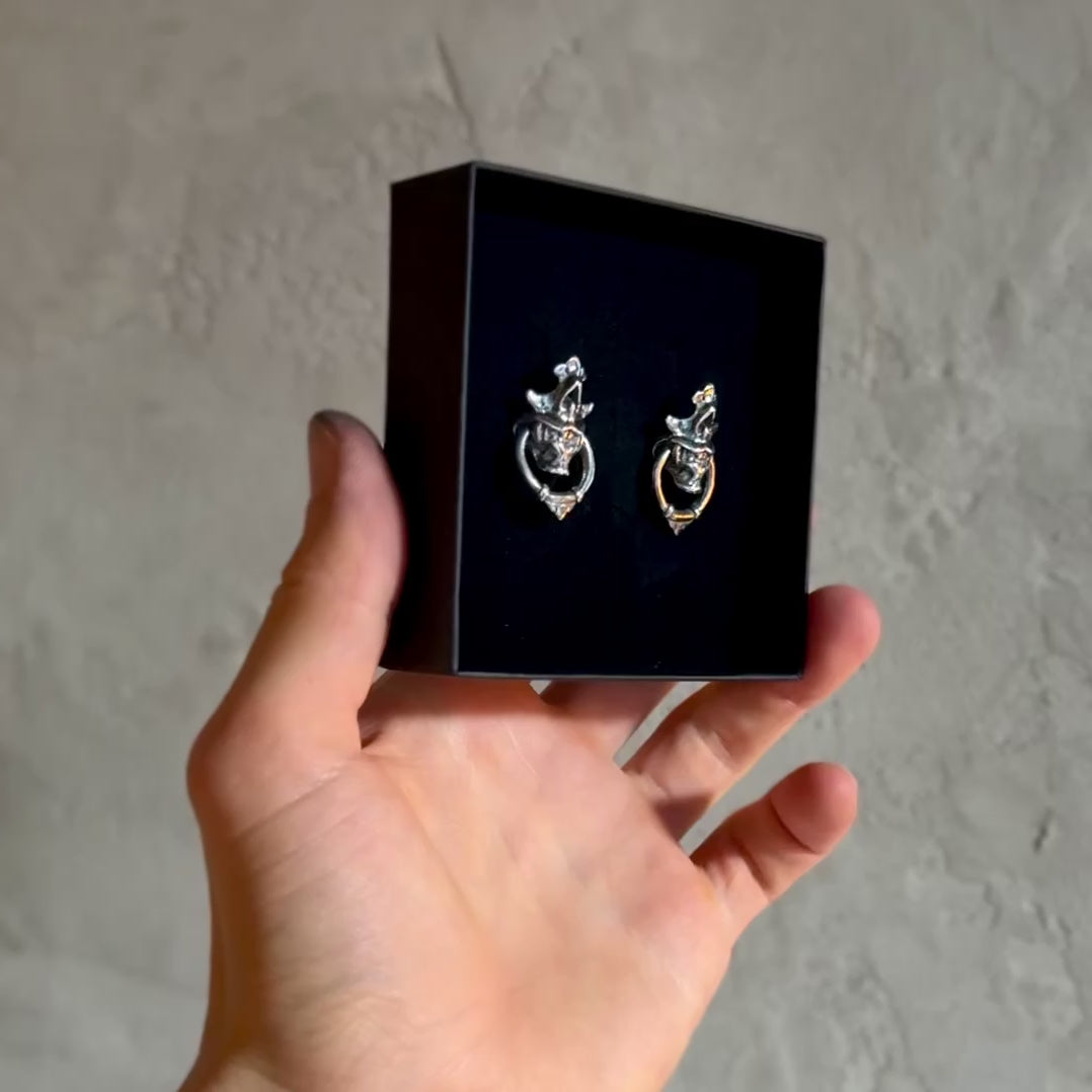 Silver Mask earring - video of two earrings set in a box
