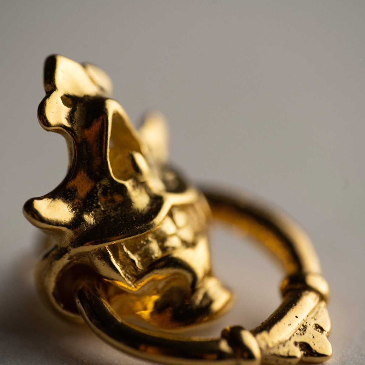 Silver Mask earring - gold plated variant, close up on the details