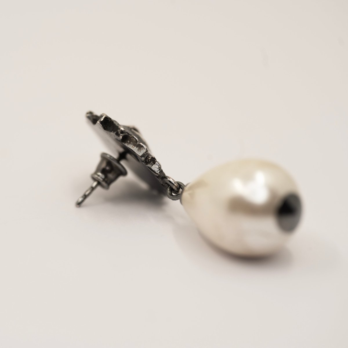 Sirius Pearl Drop earring on white surface showing sterling silver stud lock mechanism