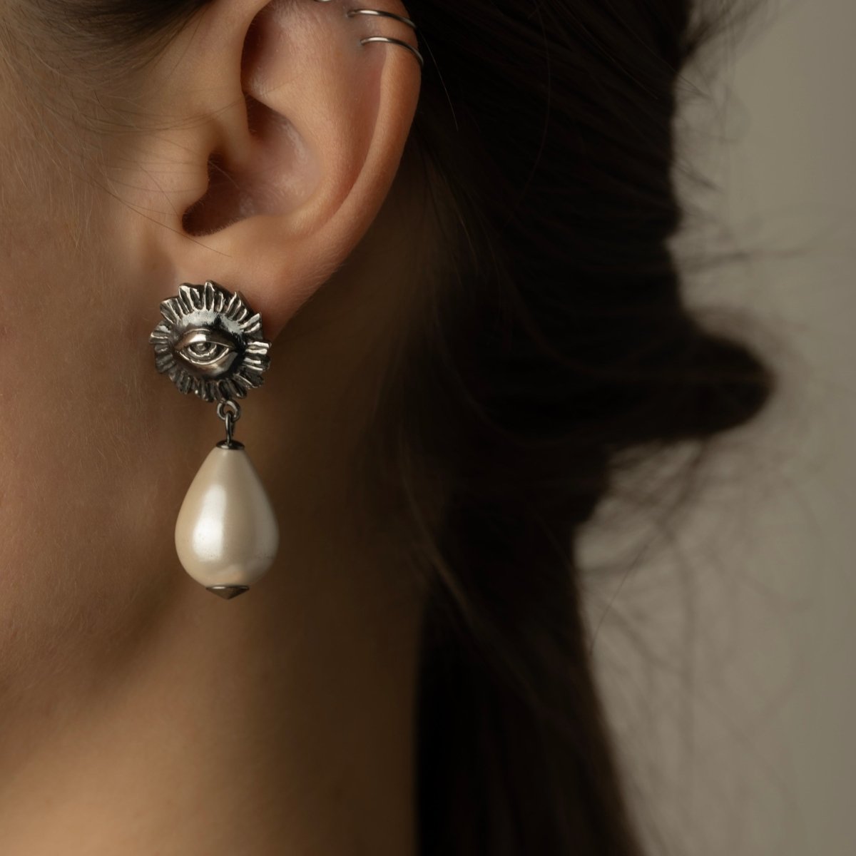 Sirius Pearl Drop earring on female model, profile view, close-up