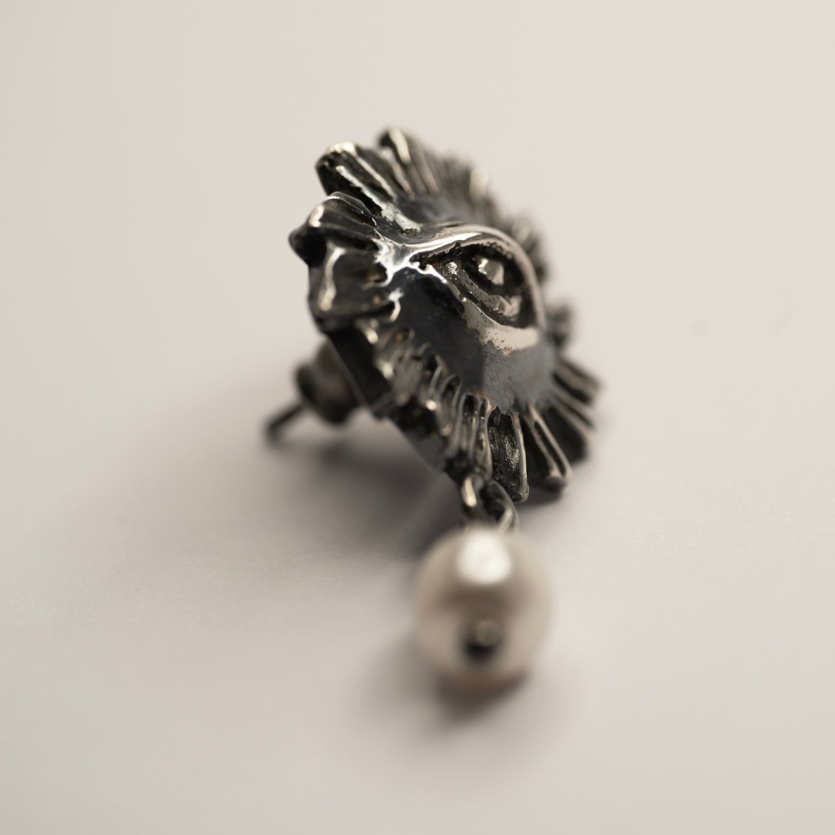 Sirius pearl earring by Macabre Gadgets on white surface showing sterling silver stud lock mechanism