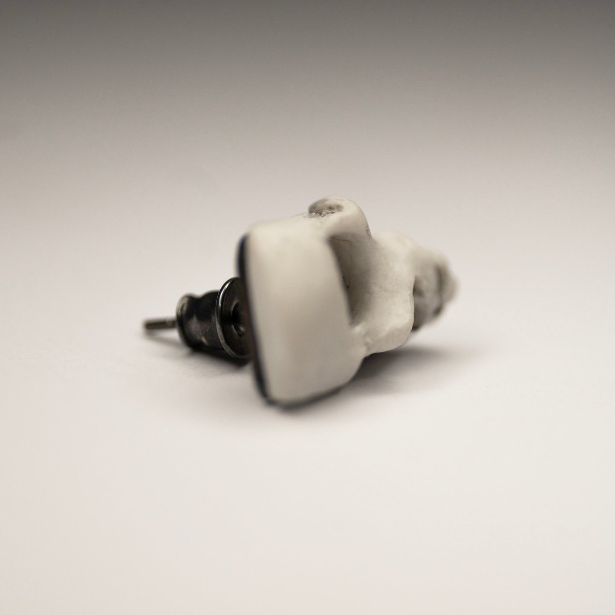 Skull Fragment earring shows sterling silver stud lock mechanism