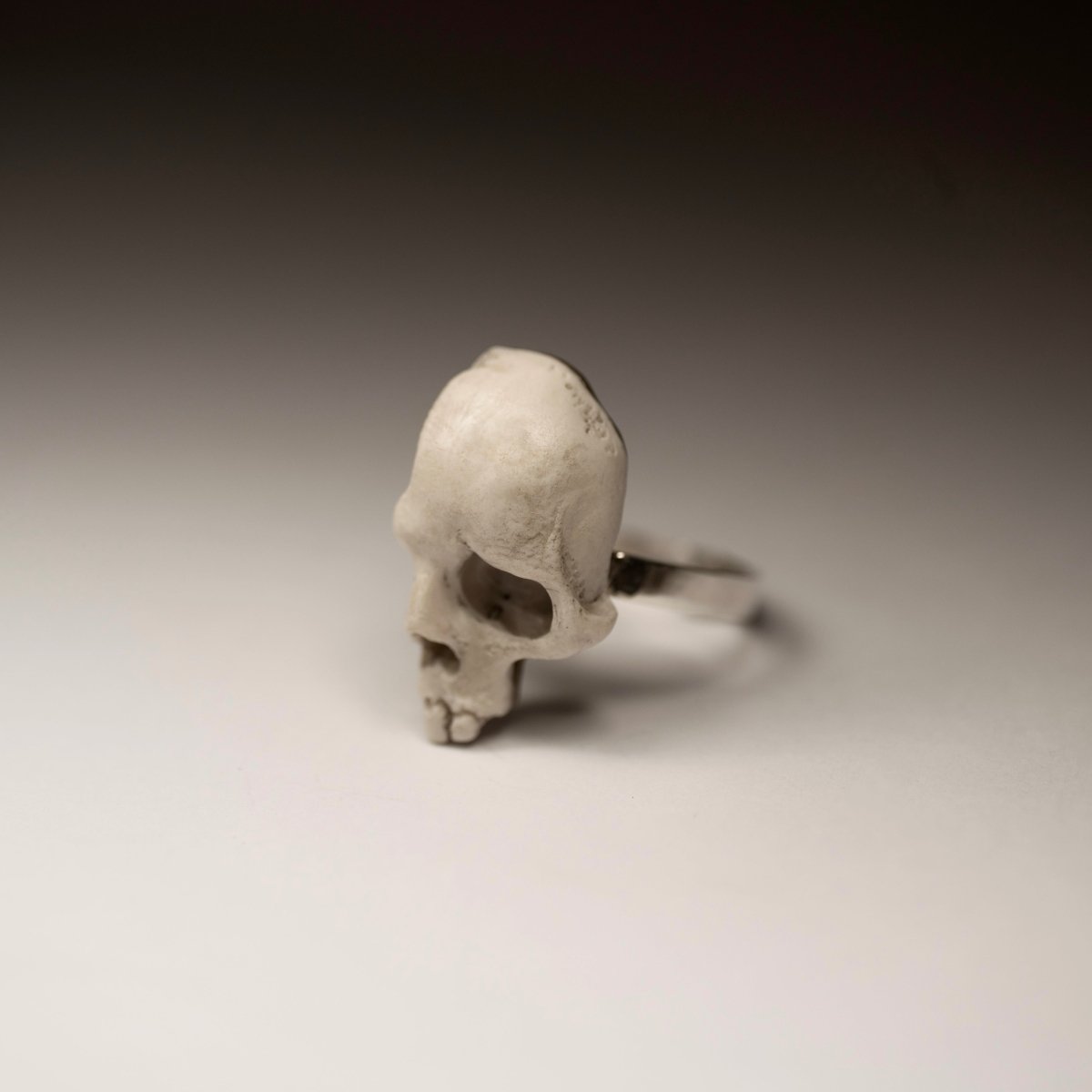 Skull Fragment ring on a grey background, semi side view