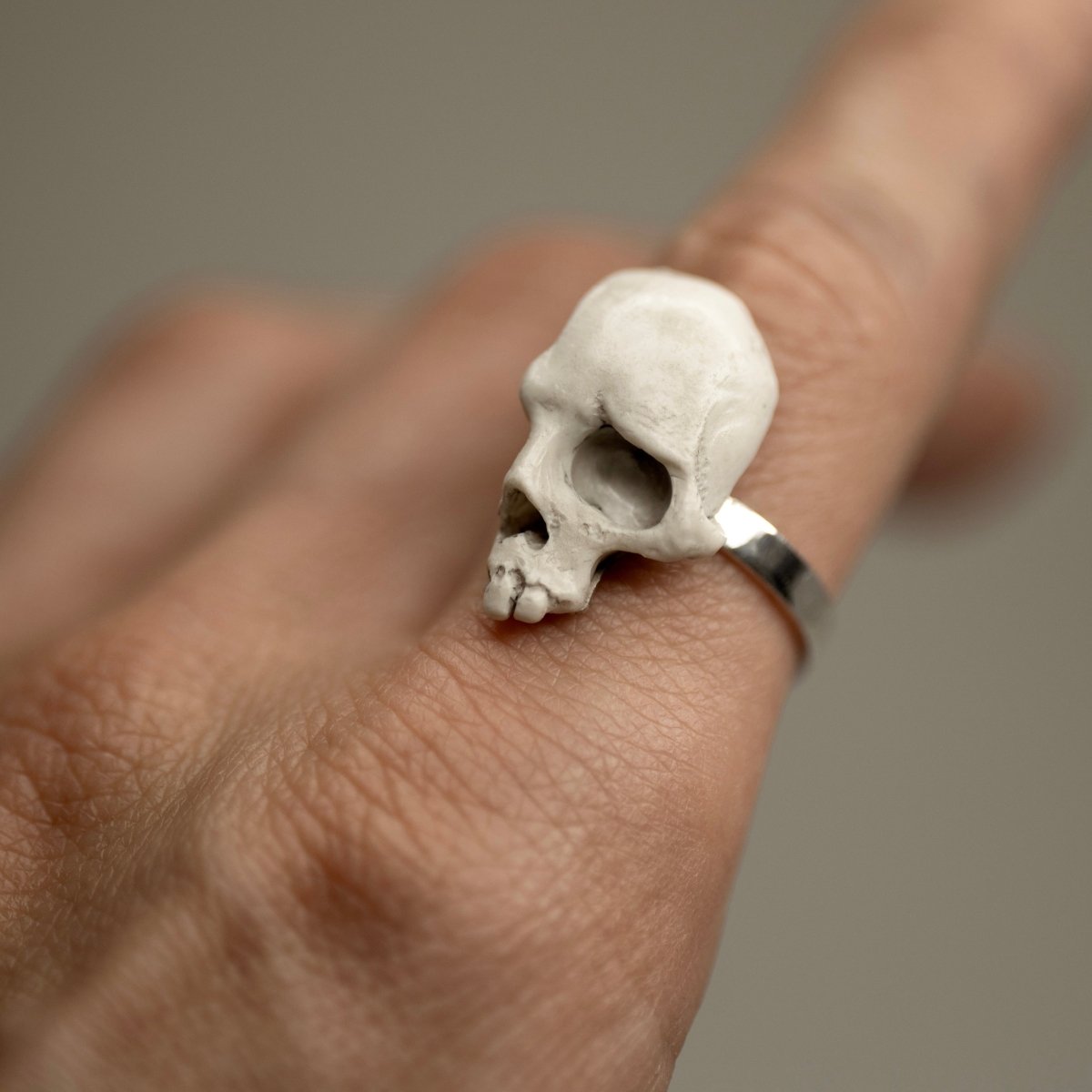 Skull Fragment ring on a male model's hand, index finger