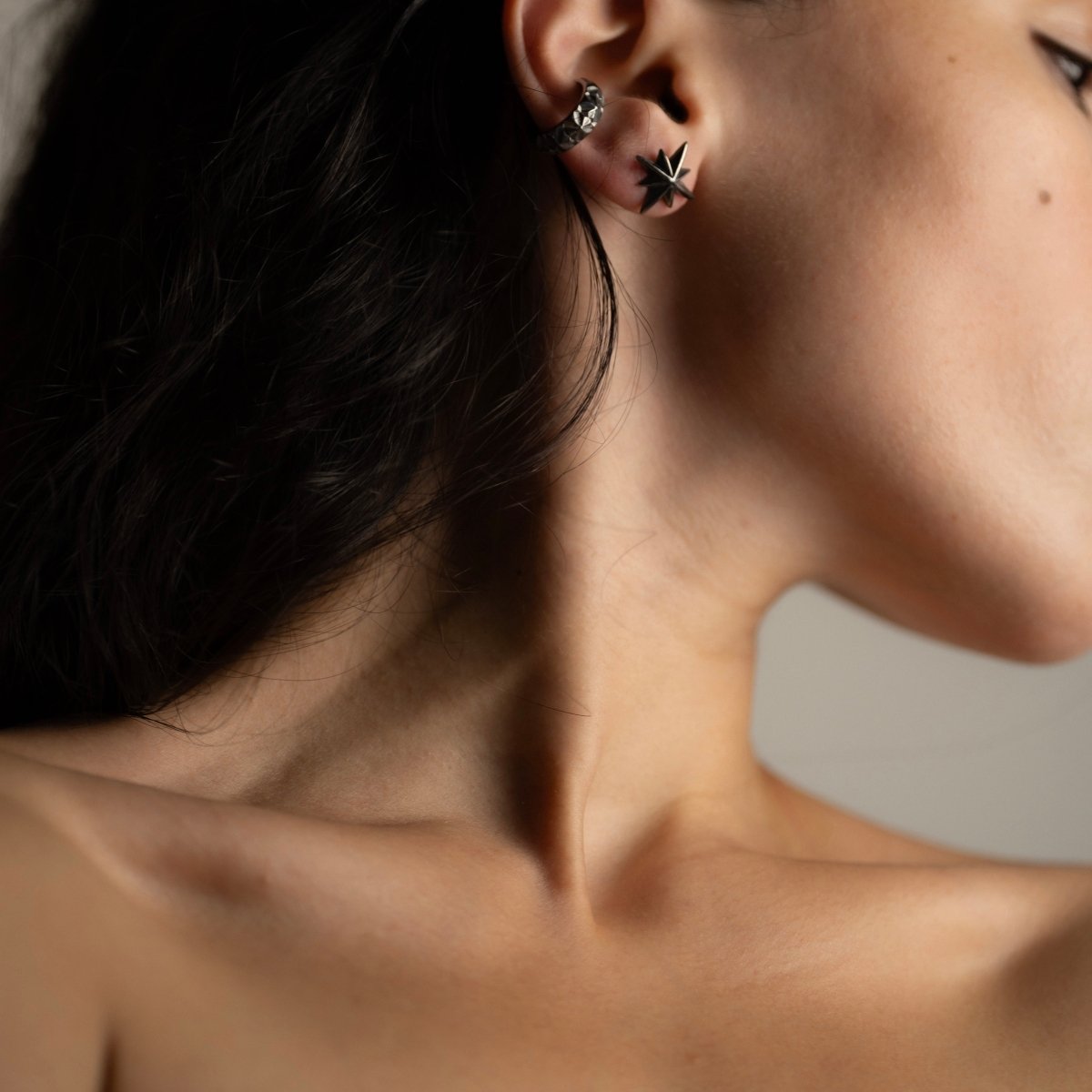 Star stud earring on a female model, shows general fit and dimensions, styled with Dragonfly ear cuff