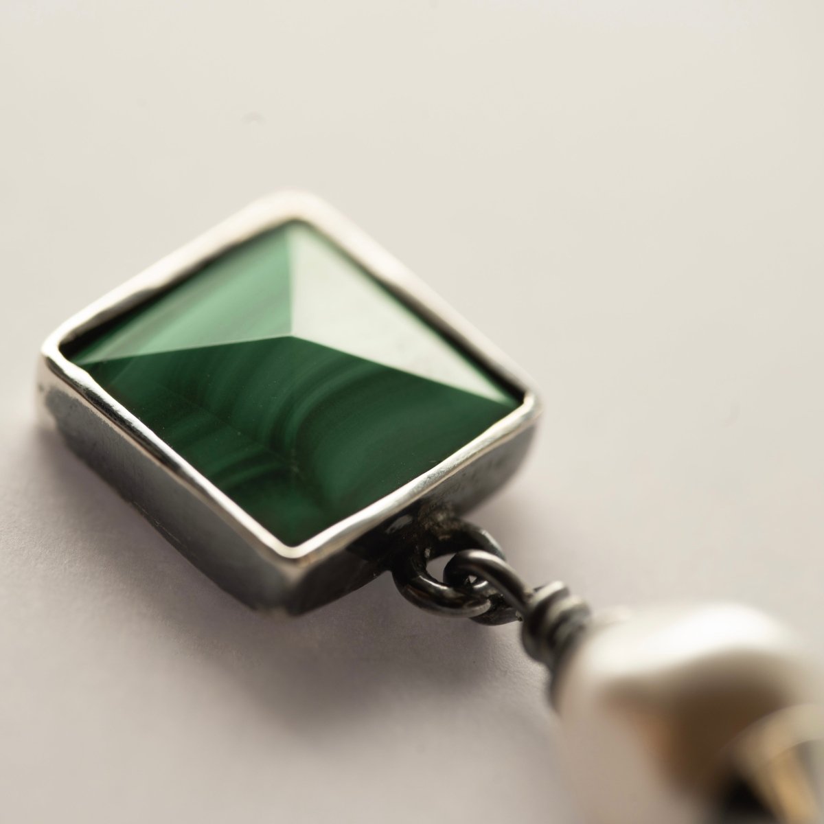 Malachite Studs earrings on neutral background showing natural green malachite stone detail and patterns