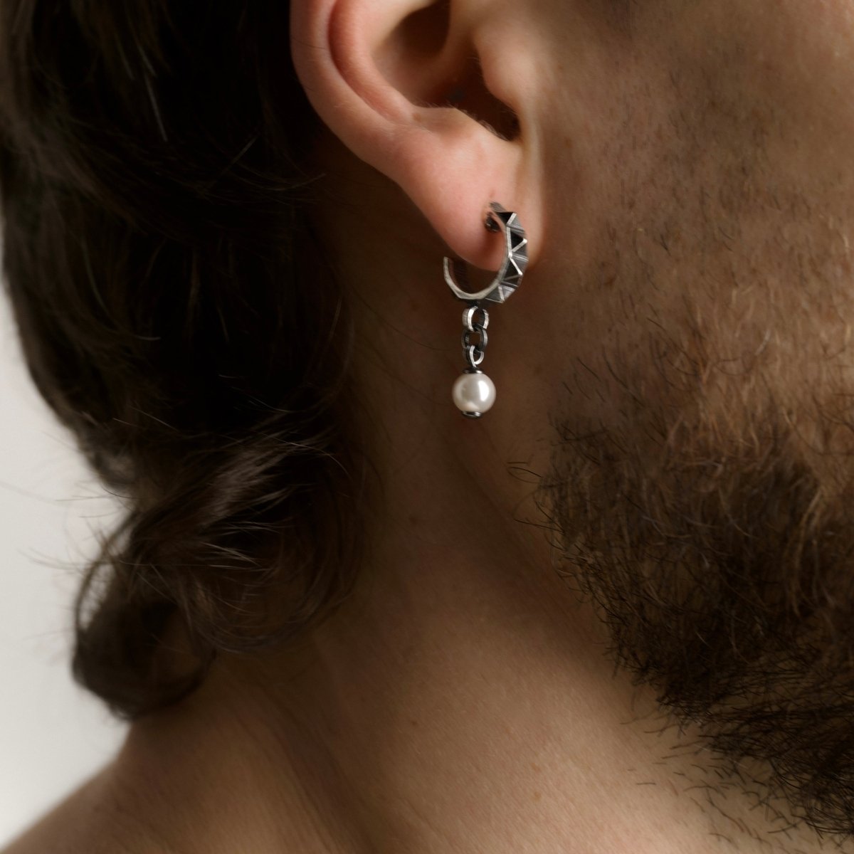 Male model wearing Studs Pearl earring in sterling silver, lifestyle shot
