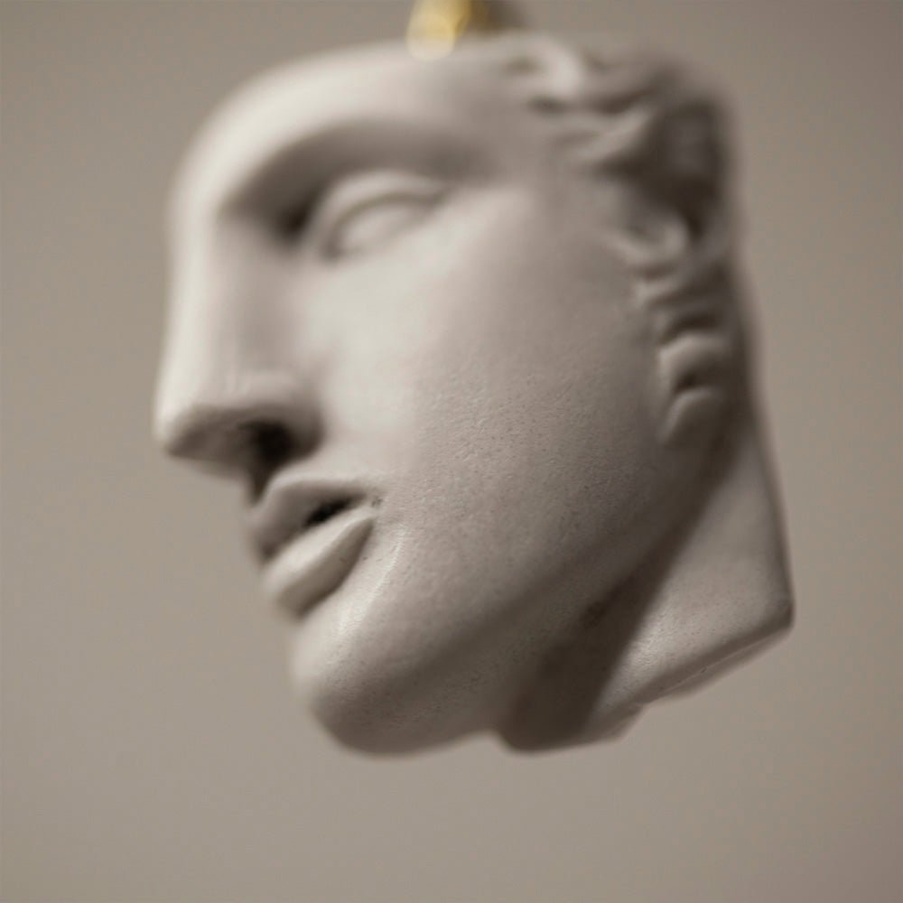 Achilles earring - close-up of marble sculpture detail, with focus on lips nose and eye