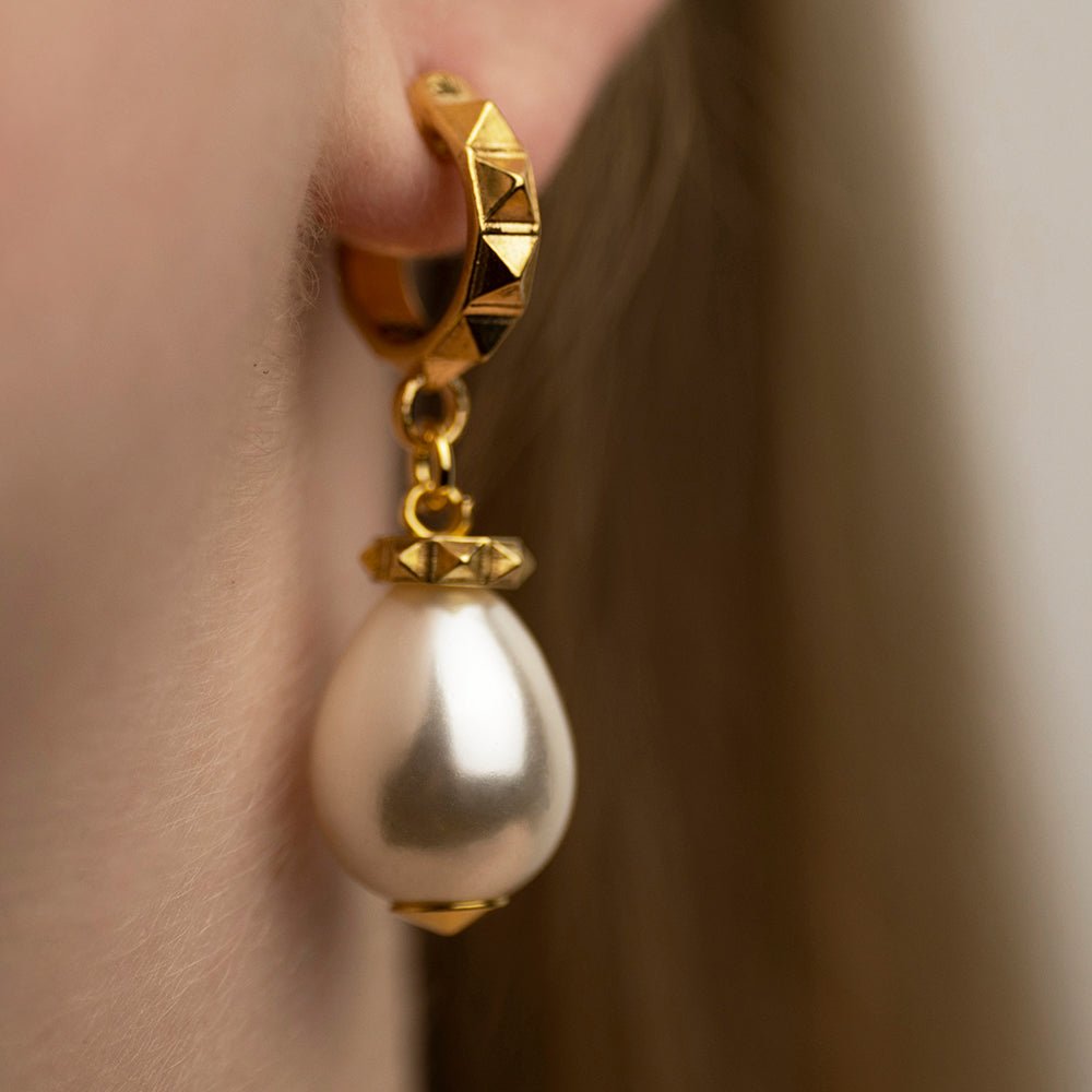 Model wearing Aeon Pearl Drop earring in gold-plated sterling silver, classic pearl drop jewelry lifestyle shot