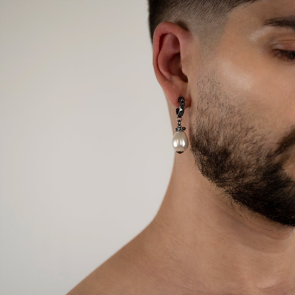 Male model wearing Aeon Pearl Drop earring in sterling silver, handcrafted timeless pearl jewelry