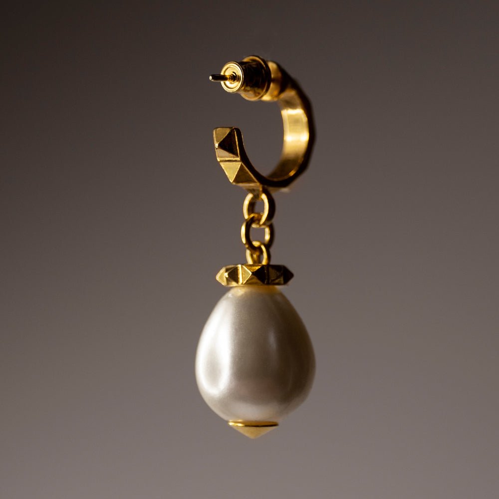 Aeon Pearl Drop earring in gold-plated finish on neutral background, timeless pearl drop jewelry detail
