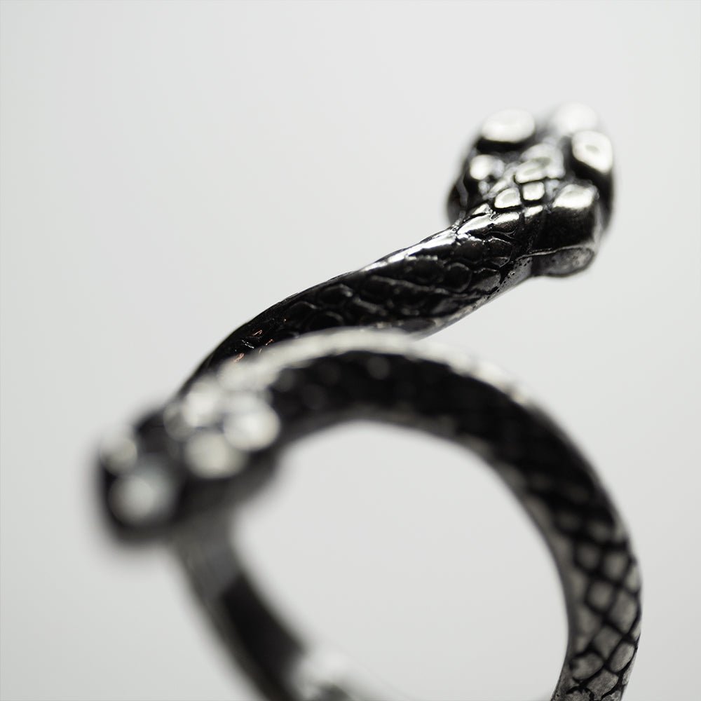 Two Headed Snake ring - close up on a blackened sterling silver surface of the ring with snake's skin texture