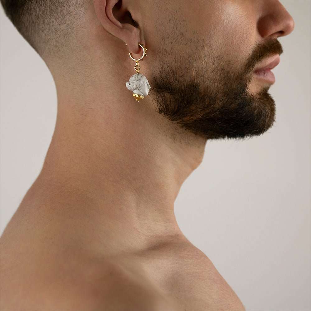 Artemis earring - miniature sculpted head in white marble on gold plated stud hoop on a male model