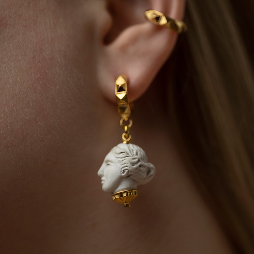 Artemis earring gold-plated on model's ear close-up, Greek mythology goddess jewelry lifestyle shot