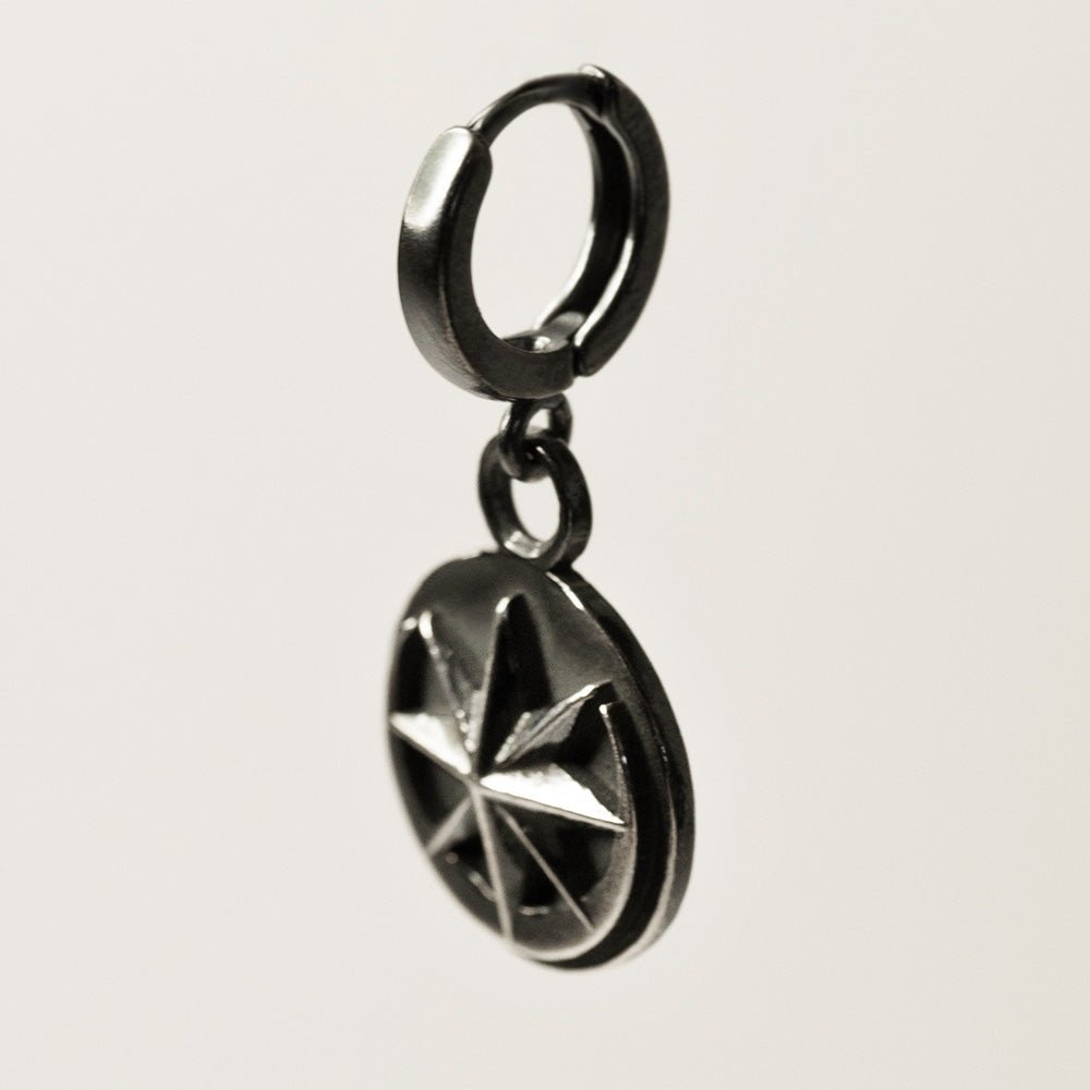 Aster earring - sterling silver coin earring on huggie clasp with star and moon design on visible side