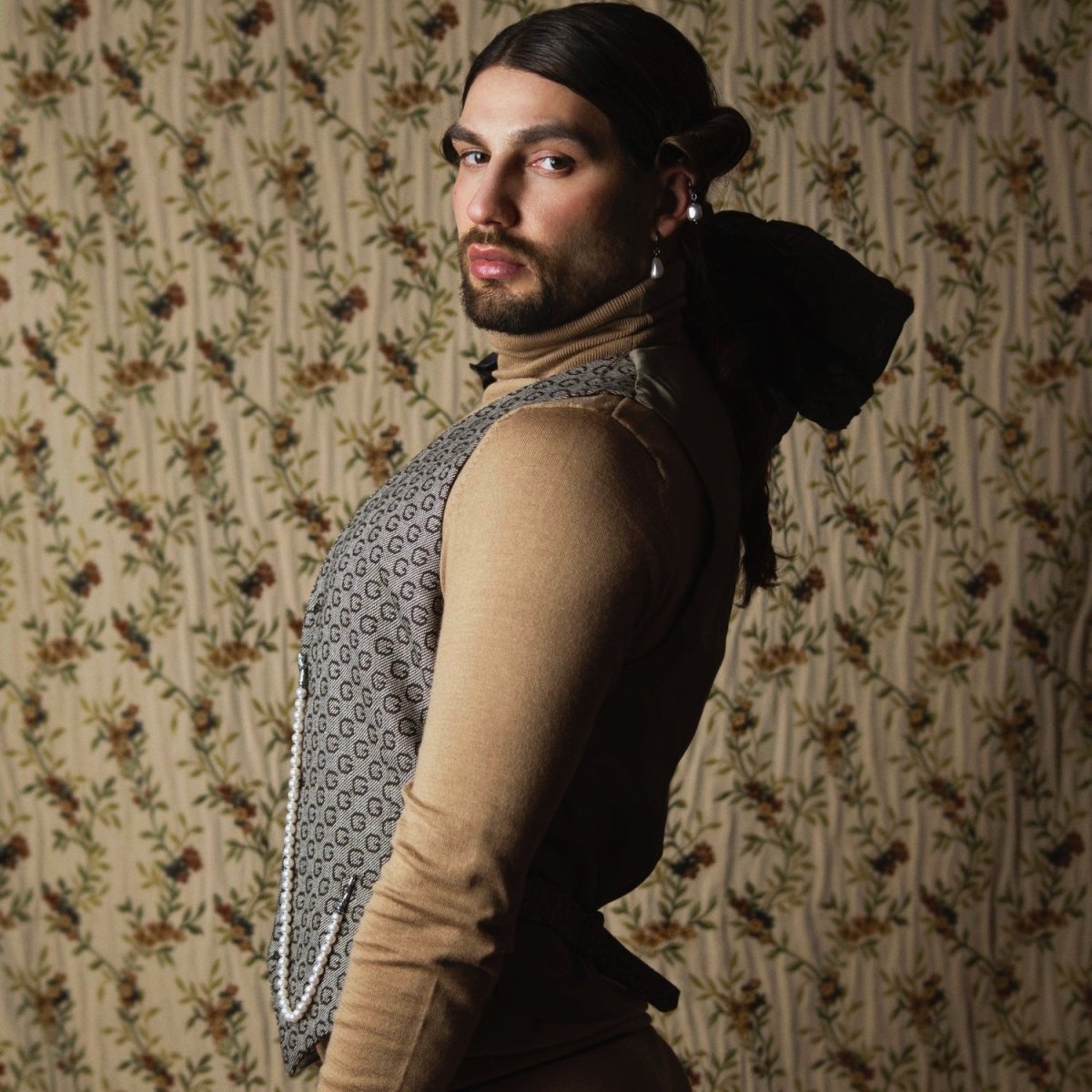 Male model in artistic fashion editorial wearing Baroque Pearl Drop earring, along with other pearl earrings by Macabre Gadgets