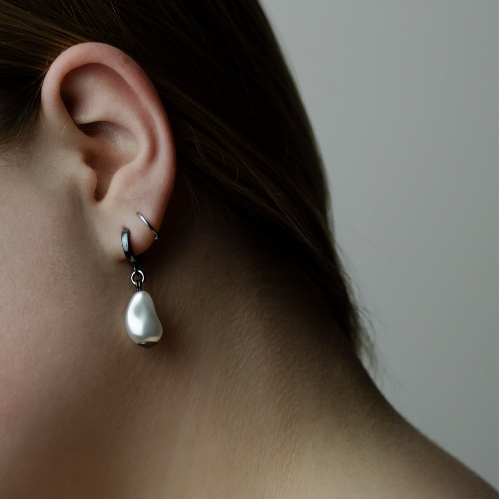 Female model wearing Baroque Pearl Drop earring - tear drop earring on silver hoop, close-up shot