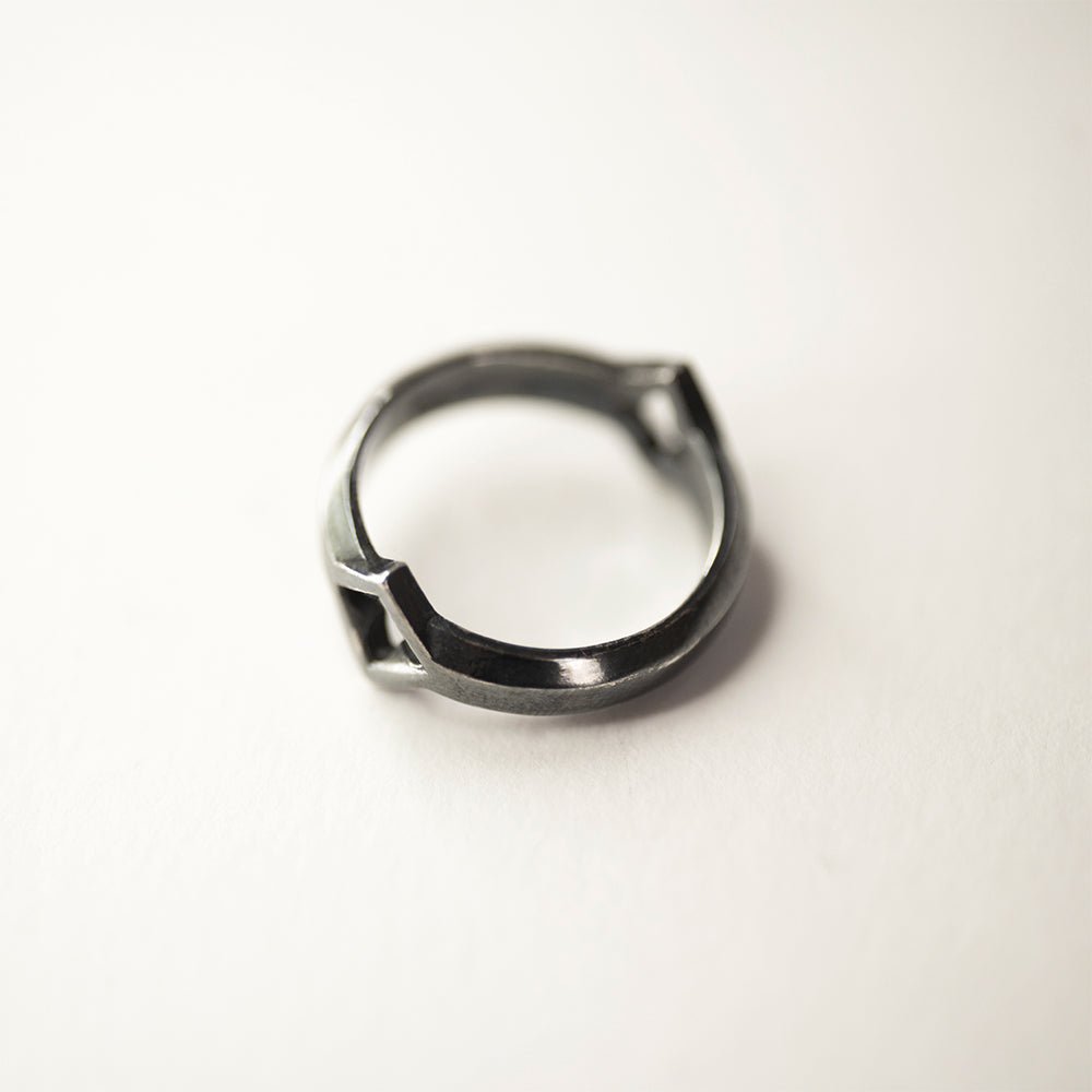 Gothic Clover Ring  lying on white surface
