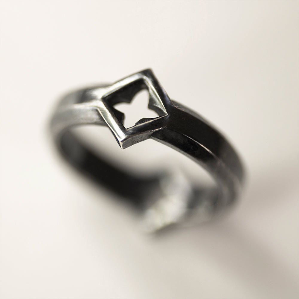 Gothic Clover Ring - close up on a white surface, focus on a clover element