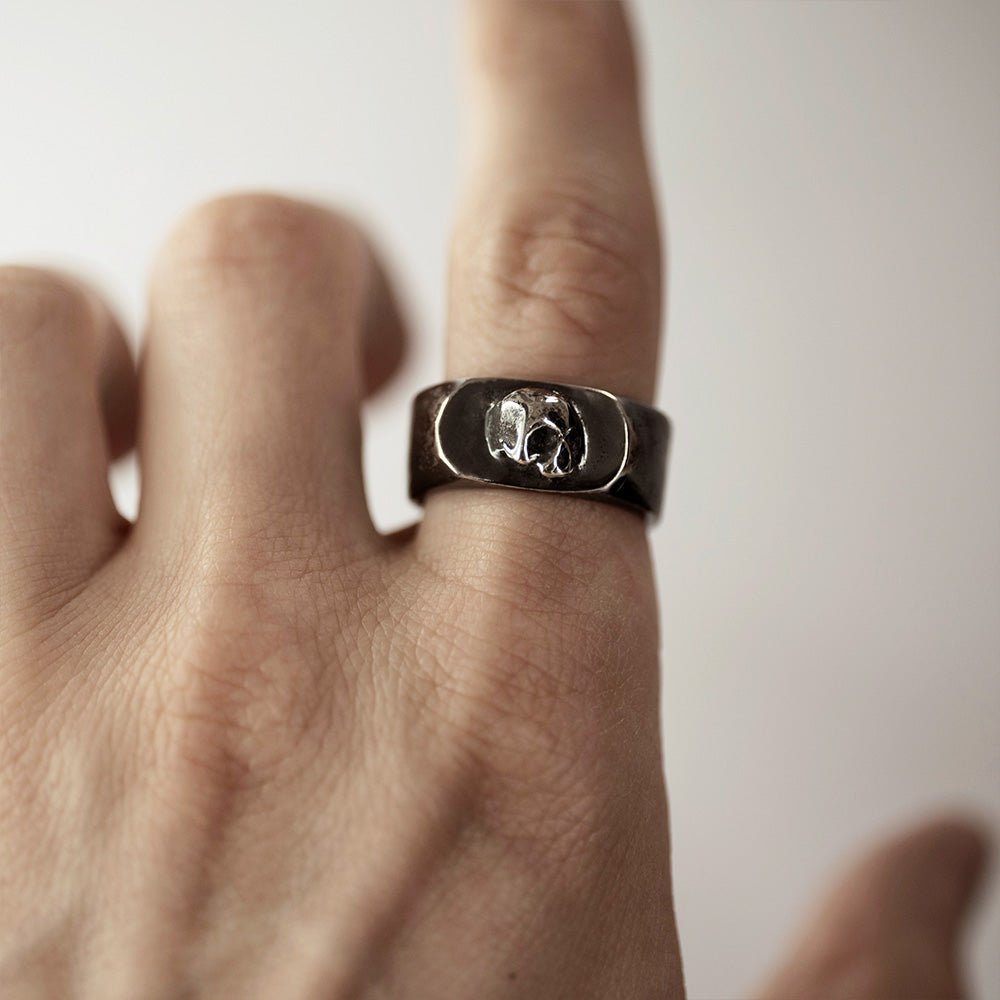Flow ring on model's  index finger - gothic skull ring styling shot
