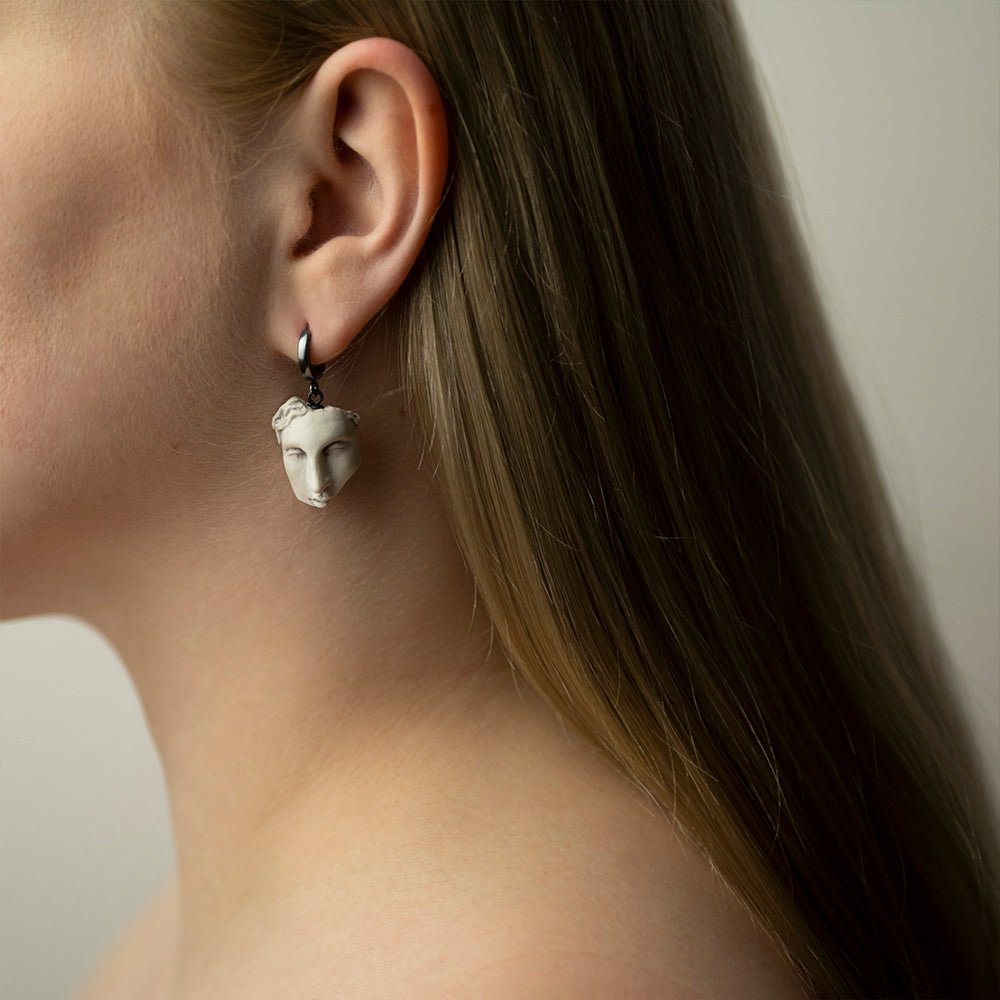 Helen earring on a female model with long straight hair, styling of sculpture earrings representation