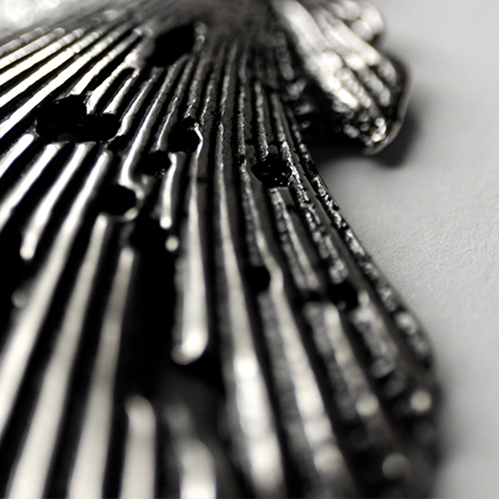Close-up of Large Seashell stud earring, focus on its sterling silver surface and texture 