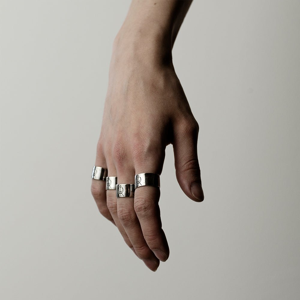 female model wearing four MG Logo rings - wide band gothic ring styling shot