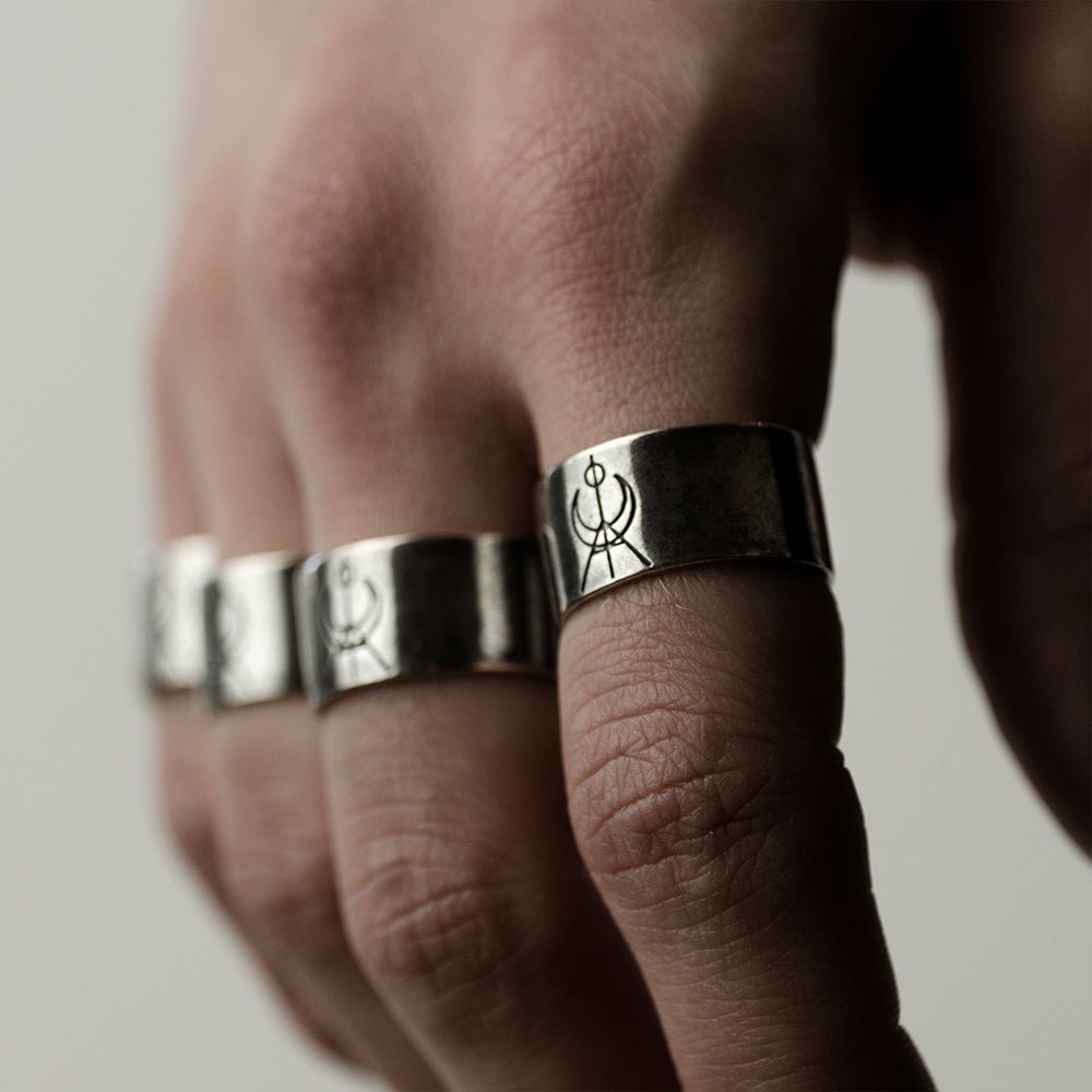 MG Logo ring - wide silver ring with geometrical logo in the centre on male model