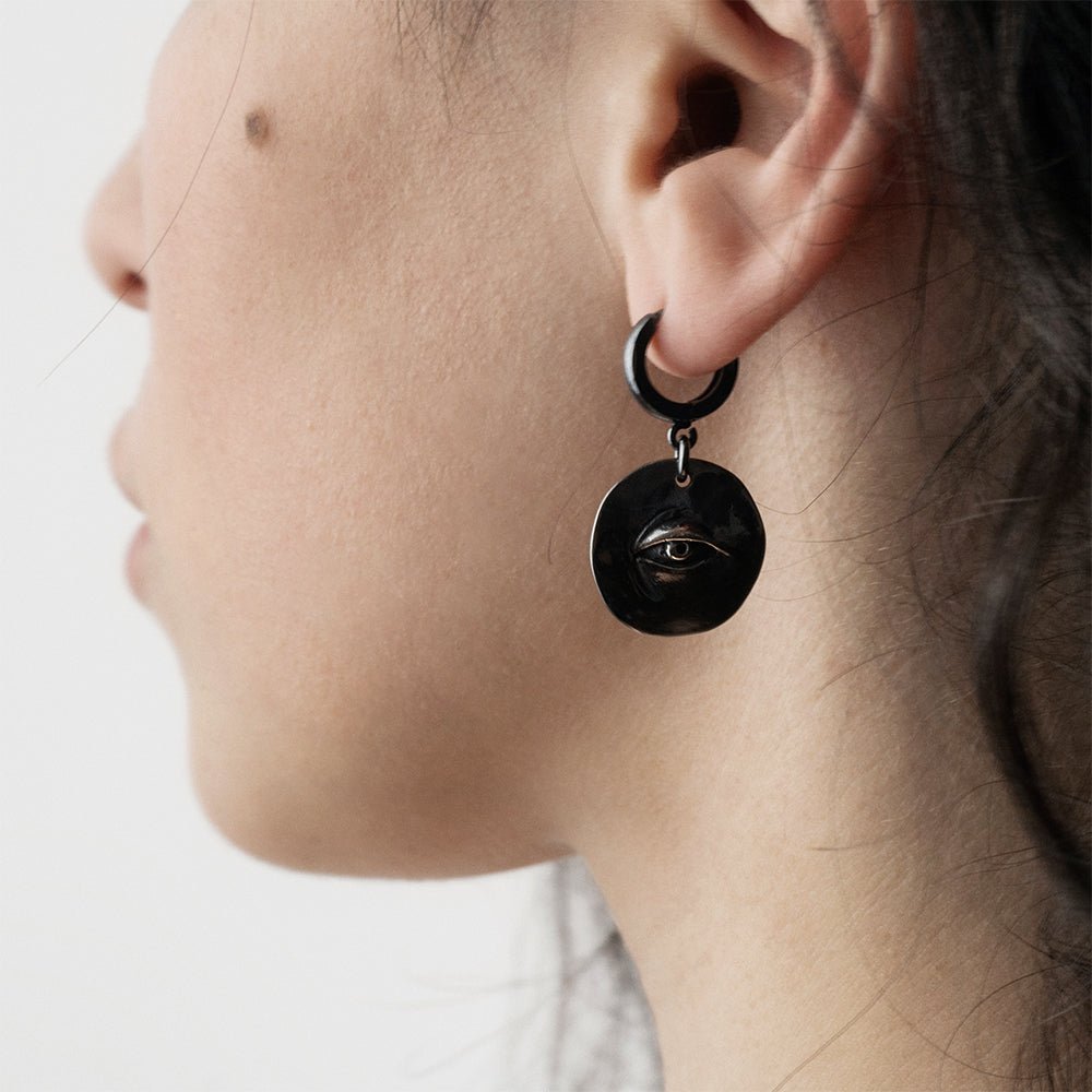 Female model wearing Oculus eye earring - close-up on sterling silver eye