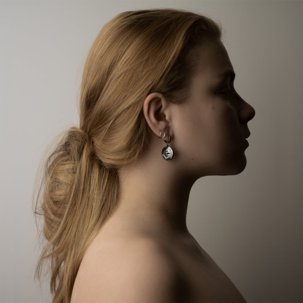 Female model wearing Oculus eye earring - sterling silver gothic earring