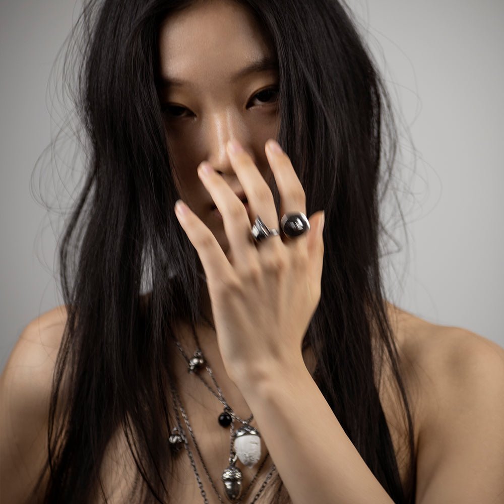 Oculus ring - on an Asian female model with long dark hair along with other rings and necklaces by Macabre Gadgets, image has a mystical, haunting presence
